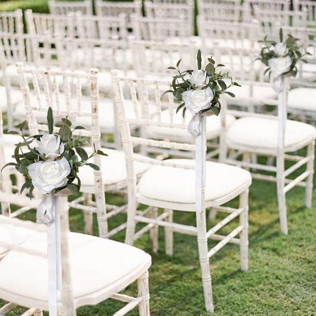Ivory rose aisle posies on white ceremony chairs